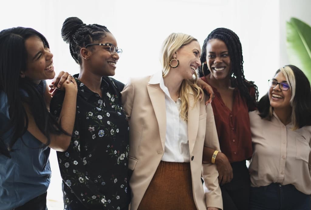 Businesswomen smiling and laughing together